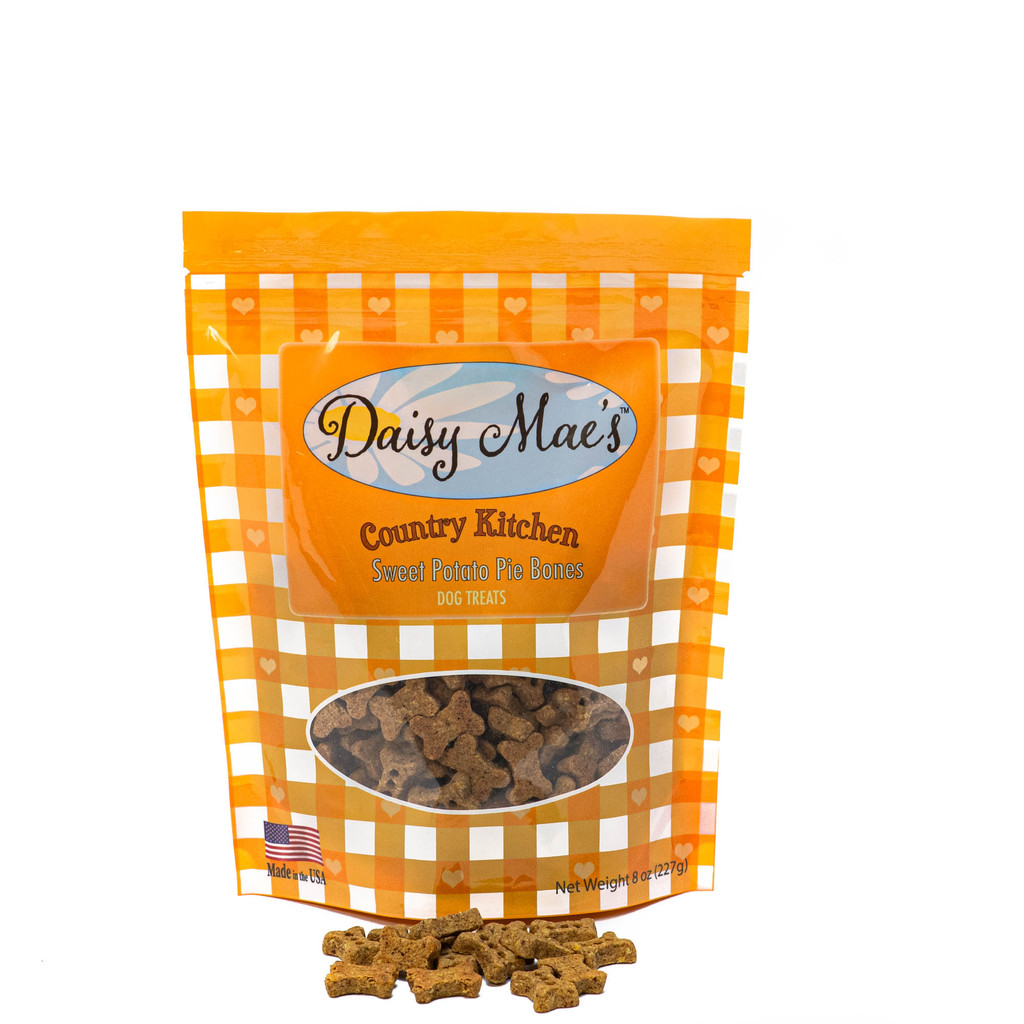 Daisy Mae's Country Kitchen™ Sweet Potato Pie Bones dog treats feature a brightly colored 8 oz. orange gingham check package.