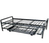 A black metal daybed frame with its pop-up steel trundle unit