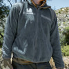 Man standing in the grass wearing the New U.S. Army Issue Gen III PolarTec Fleece Jacket in the color foliage