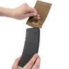 Right hand hold the mag with the left hand holding the Elastic Single Rifle Mag Pouch in the color coyote