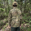 back view on a man of the U.S. Army Issue OCP Level 4 Wind Jacket in the woods