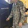man adjusting a large fan wearing a Military Issue CVC Coveralls FR, UCP/ACU 