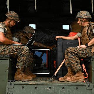 Soldiers sitting in the back of a military vehicle