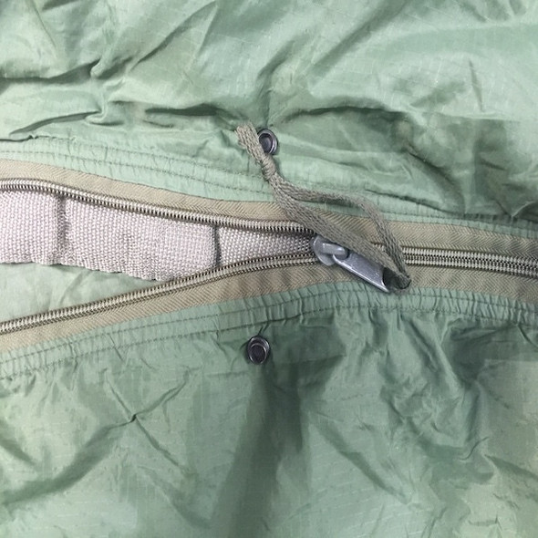 Close up of the zipper on the U.S. Issue Olive Patrol Sleeping Bag, Used Close up of the zipper on the U.S. Issue Olive Patrol Sleeping Bag, Used