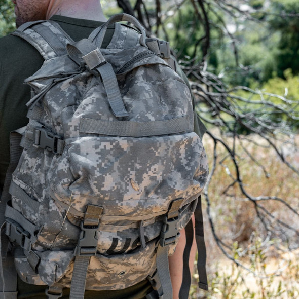 Man in the woods wearing the U.S. Army Issue ACU Assault 3 Day Backpack Man in the woods wearing the U.S. Army Issue ACU Assault 3 Day Backpack