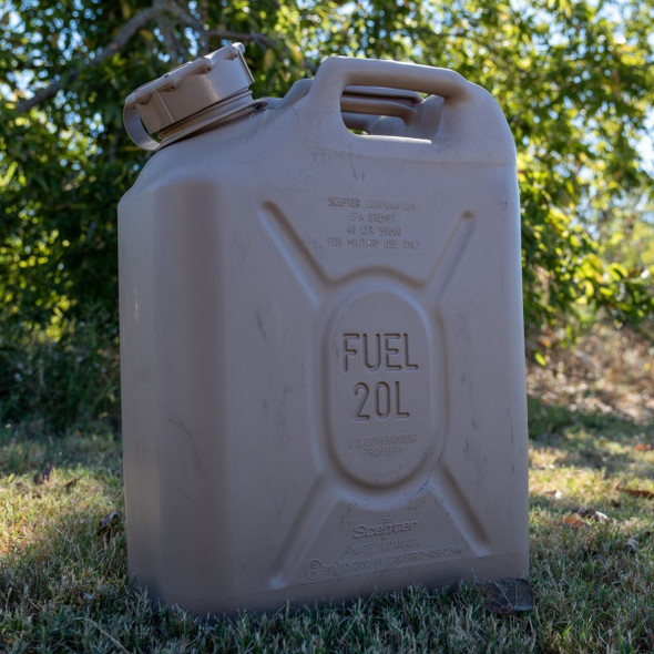 Scepter Military Issue 5 Gallon Fuel Can outside standing up in the grass  Scepter Military Issue 5 Gallon Fuel Can outside standing up in the grass