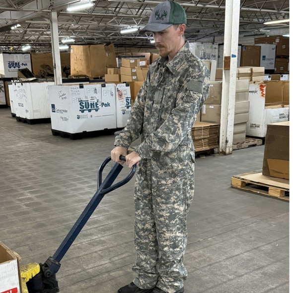 man pulling a hand truck wearing a Military Issue Mechanics Coveralls, UCP/ACU