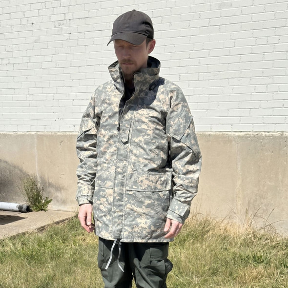 Model wearing military issue acu ucp rain jacket