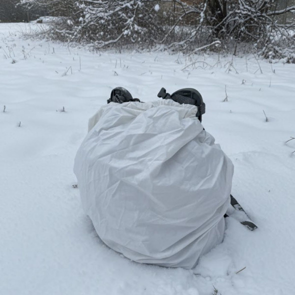 white poly cotton military backpack cover on a rucksack in the snow 