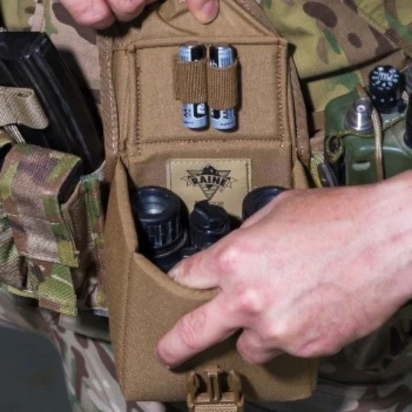 a person using the U.S. Made NVG Padded MOLLE Case open with batteries in the elastic straps and a NVG inside