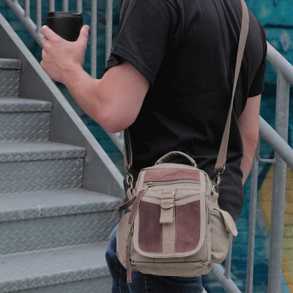 Man wearing the Rothco Vintage Canvas and Leather Travel Shoulder Bag walking up stairs  Man wearing the Rothco Vintage Canvas and Leather Travel Shoulder Bag walking up stairs