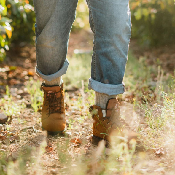 Model outside in a field wearing the Mid-calf sock