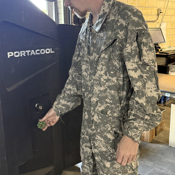 man adjusting a large fan wearing a Military Issue CVC Coveralls FR, UCP/ACU 