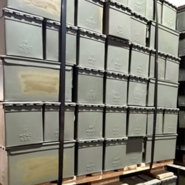 pallet of ammo cans with olive paint covering the writing 