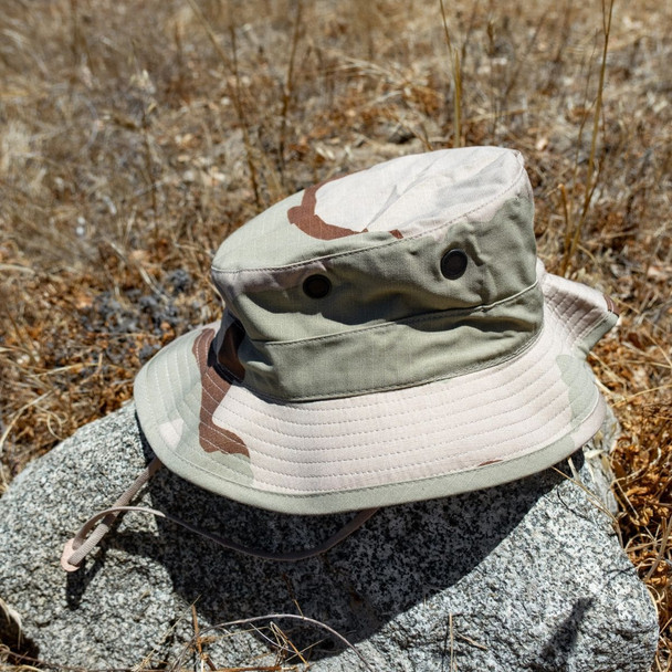 The U.S. Issue Desert Camo Boonie Hat, NyCo Rip-Stop sitting on a rock