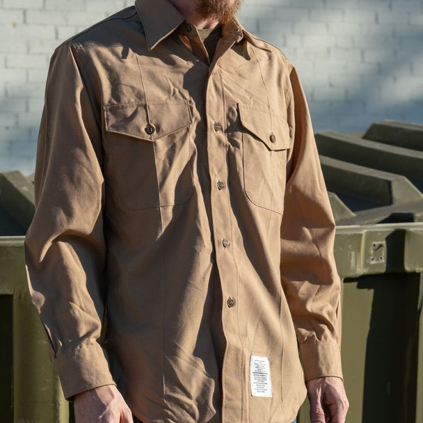 Man wearing the USMC Men's Long Sleeve Khaki Shirt outside in front of a brick wall
