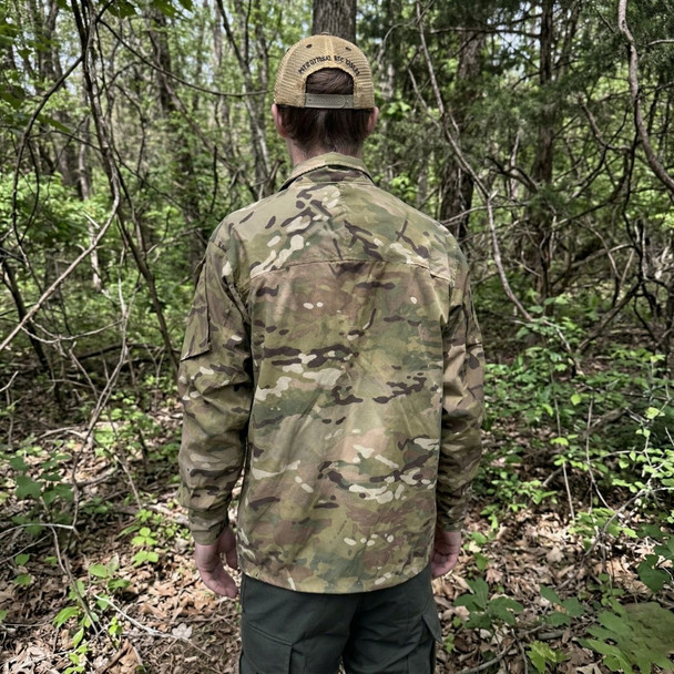back view on a man of the U.S. Army Issue OCP Level 4 Wind Jacket in the woods