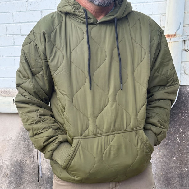 a man wearing a woobie hoodie olive rip stop 