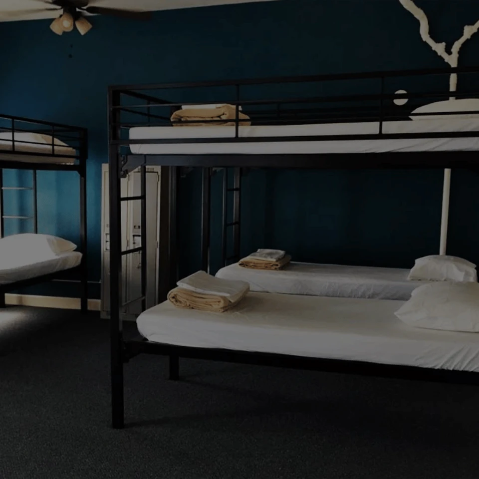 Steel bunk beds in a dim barracks room