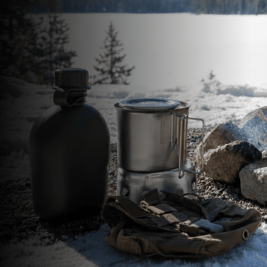 canteen and cook set near a f ire in a snowy environment with text