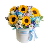 sunflowers and light blue flowers in a box.