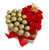 Red roses and Ferrero chocolates in a heart shaped box with a red bow.