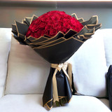 100 red roses bouquet with black paper.