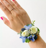 white mini roses corsage on a wrist band.