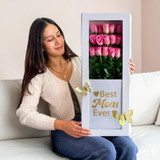 Woman holding a Best Mom Ever flower box with pink roses in a white gift box decorated with gold butterflies, elegant Mother’s Day floral gift arrangement