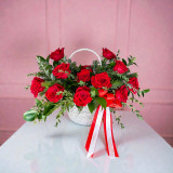 Luxury red rose basket arrangement featuring premium red roses, lush greenery, and an elegant white woven basket with ribbon, perfect for Valentine’s Day, anniversaries, and romantic celebrations.