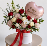 Luxury pink, blush, and white rose bouquet in a white hat box with ribbon, romantic flower arrangement with heart-shaped “I love you” balloon, premium floral gift for anniversary, birthday, Valentine’s Day, and special occasions.