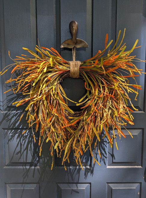 Autumn wreath in bright fall colors hung on a door