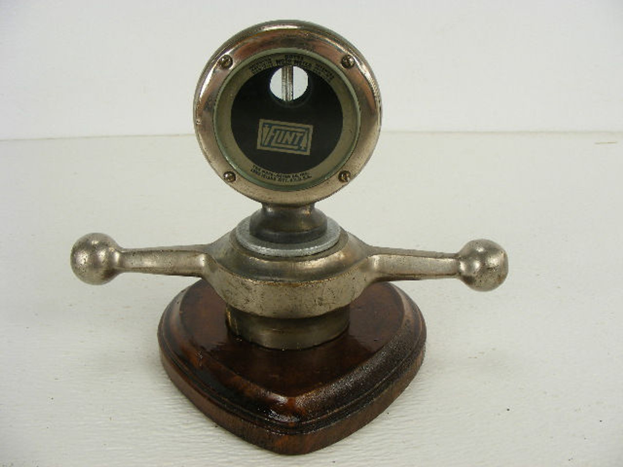 This is a rare antique Flint automobile radiator mascot temperature gauge  with dogbone from the 1920s and made by The Moto Meter Co. of Long 