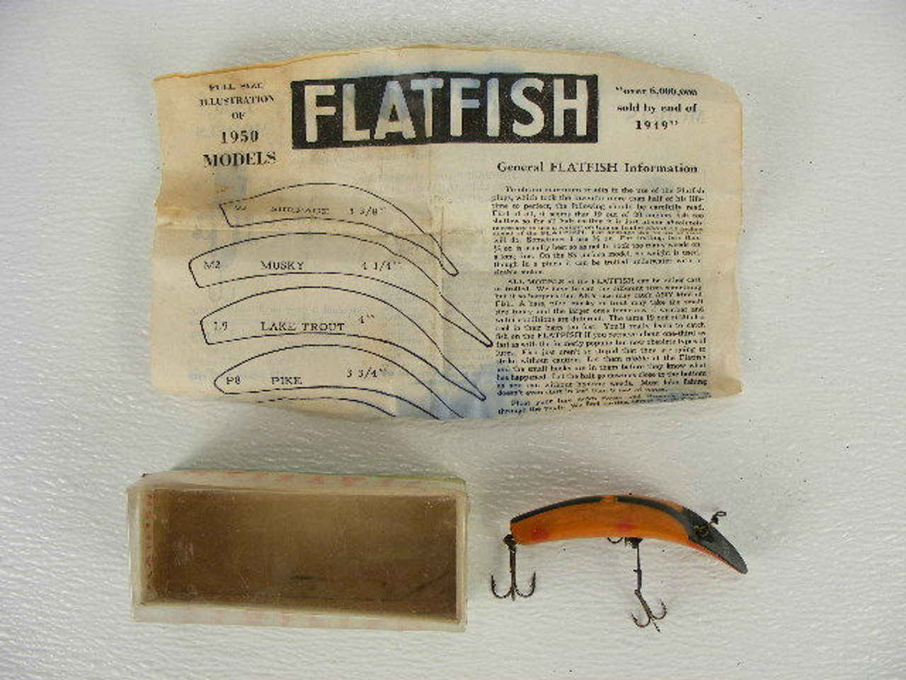A vintage Flatfish lure in the original box from 1950. - Antique Mystique