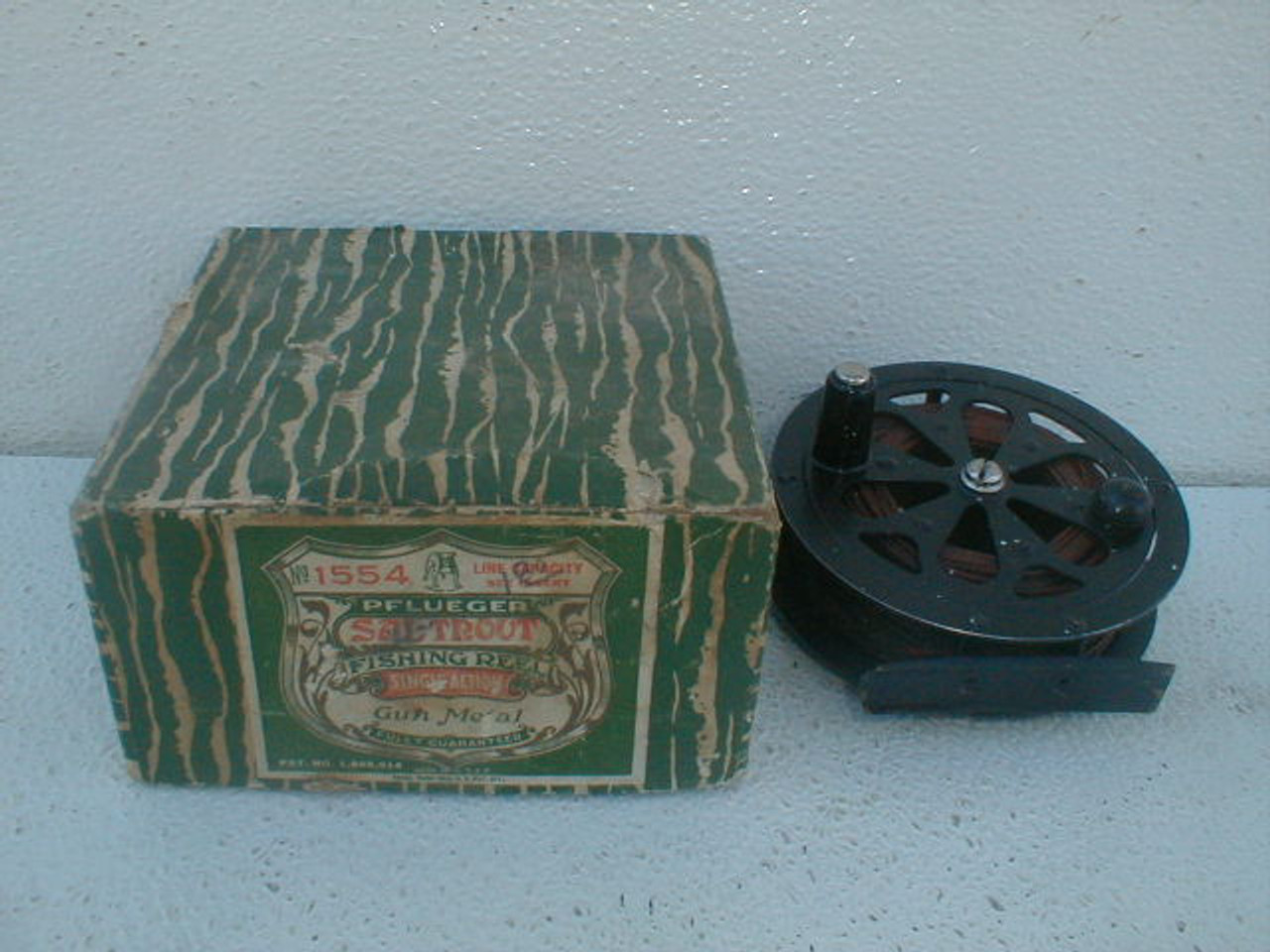 An old Pflueger Sal-Trout single action gun metal #1554 fishing reel with  its original box. - Antique Mystique