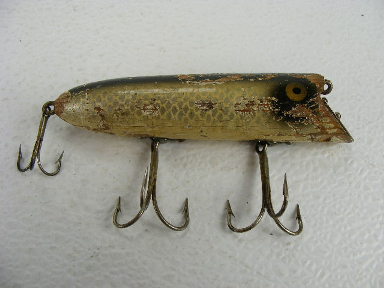 This 4 antique Heddon Basser wood fishing lure is from the 1920s and has  paint wear.