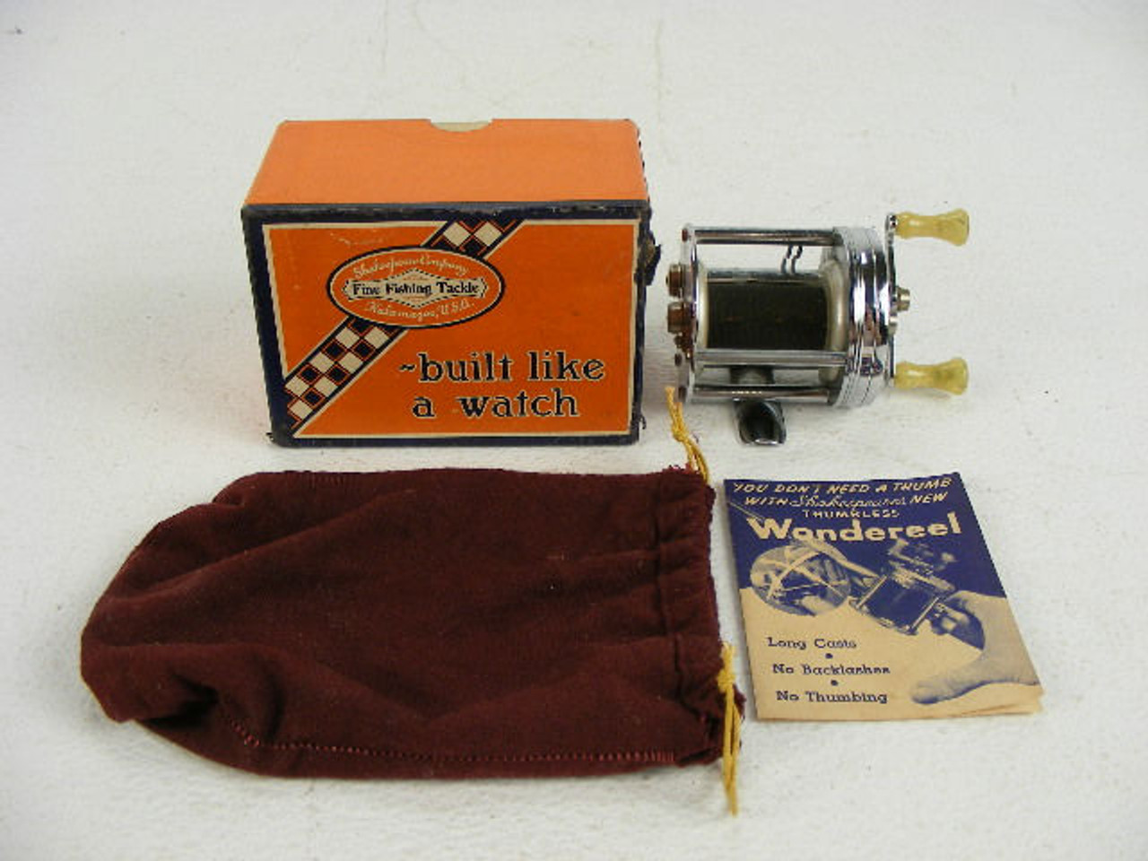 This antique Shakespeare Wondereel fishing reel comes with its box,instructions  and a cloth reel pouch. - Antique Mystique