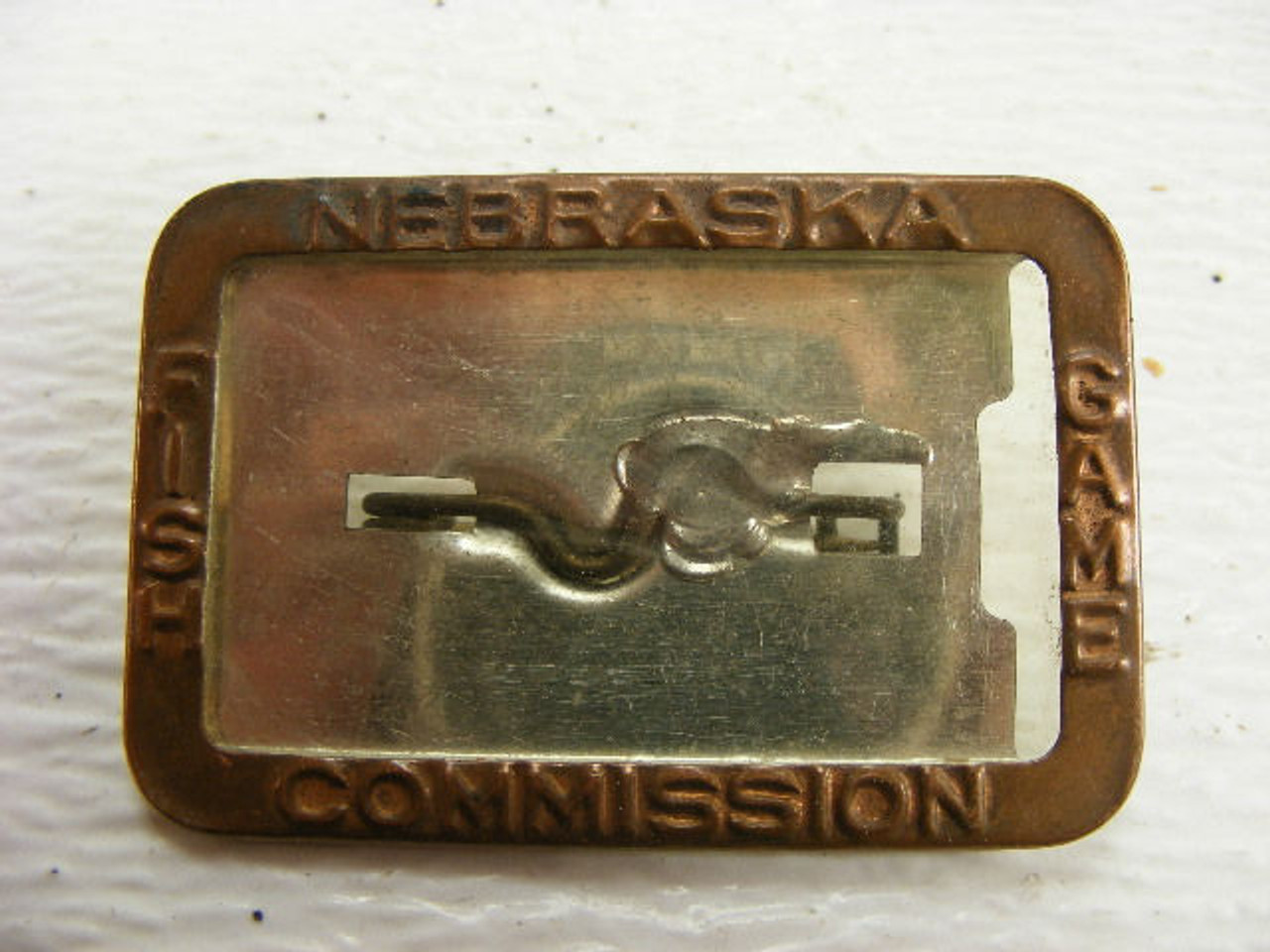 A vintage hunting license badge holder from the Nebraska Fish & Game