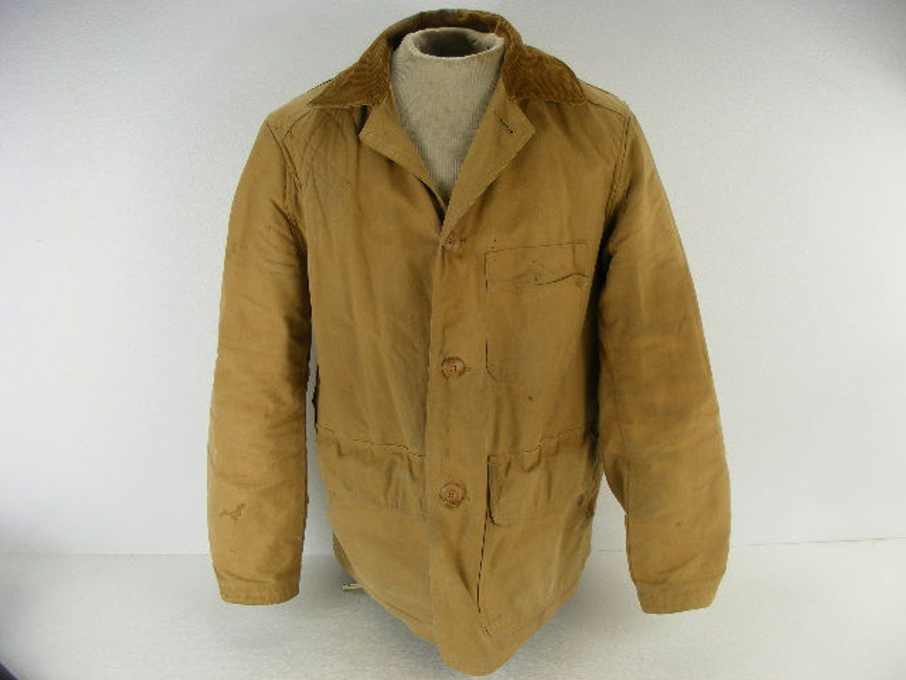 A vintage JC Higgins hunting jacket with wear from real hunting