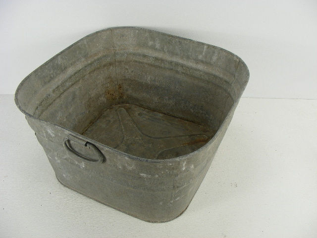 An old square wash tub with handles that measures 21" x 21" x 11