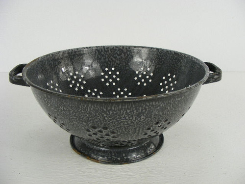 An 11" dark old gray enamel colander with use wear.