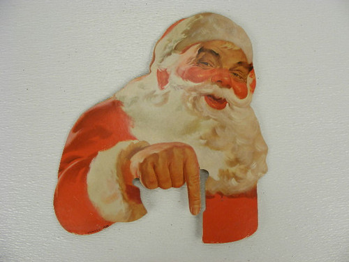 An old Santa Claus cardboard figure that may be from a Coca Cola display that measures 11&quot; x 10&quot;.