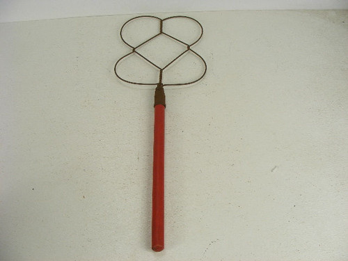 Old decorative twist wire rug beater red paint