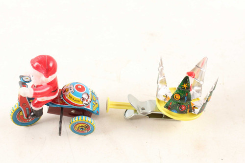 2 Vintage Santa Claus Riding Wind Up & Spinning Tree Tin Litho Toys