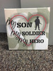 My Son, Soldier, Hero Framed Canvas Print Wall Art — Camo-patterned canvas with text in red and black, heart graphic,