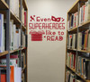 School Wall Decals Superheroes Like To Read Library Vinyl Art Stickers — Red wall decal with text and graphics in a library