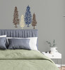 Spruce Tree Wall Decals Woodland Forest Theme Wall Art — Colorful tree decals in various heights on a gray wall above a bed