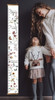 Wildflower Growth Chart Canvas Print Girls Height Ruler — Height chart with floral designs, hung on a dark wall, with two