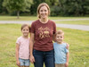 Mama Bear T-Shirt for Moms Stylish Soft Tee — Woman in a maroon shirt stands with two children in a grassy park