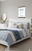 Customized Bow Canvas Art with Cursive Name Sign Print — Soft blue bedding layered with cozy throws against a light gray wall
